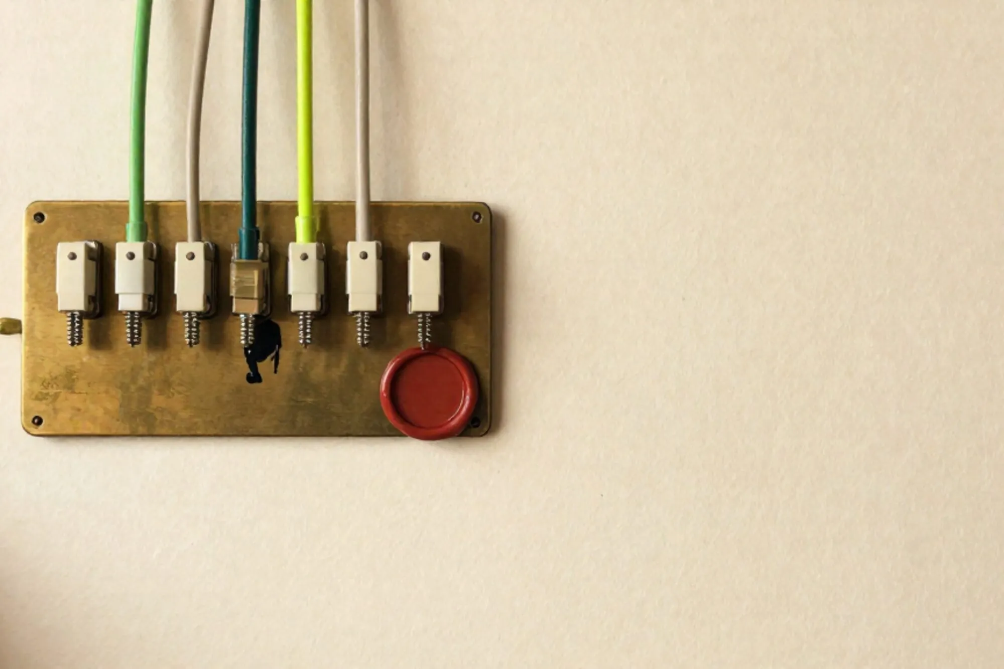 Brass switchboard with seven cream paper tags, one glowing chartreuse patch cord, red wax seal on ivory paper.