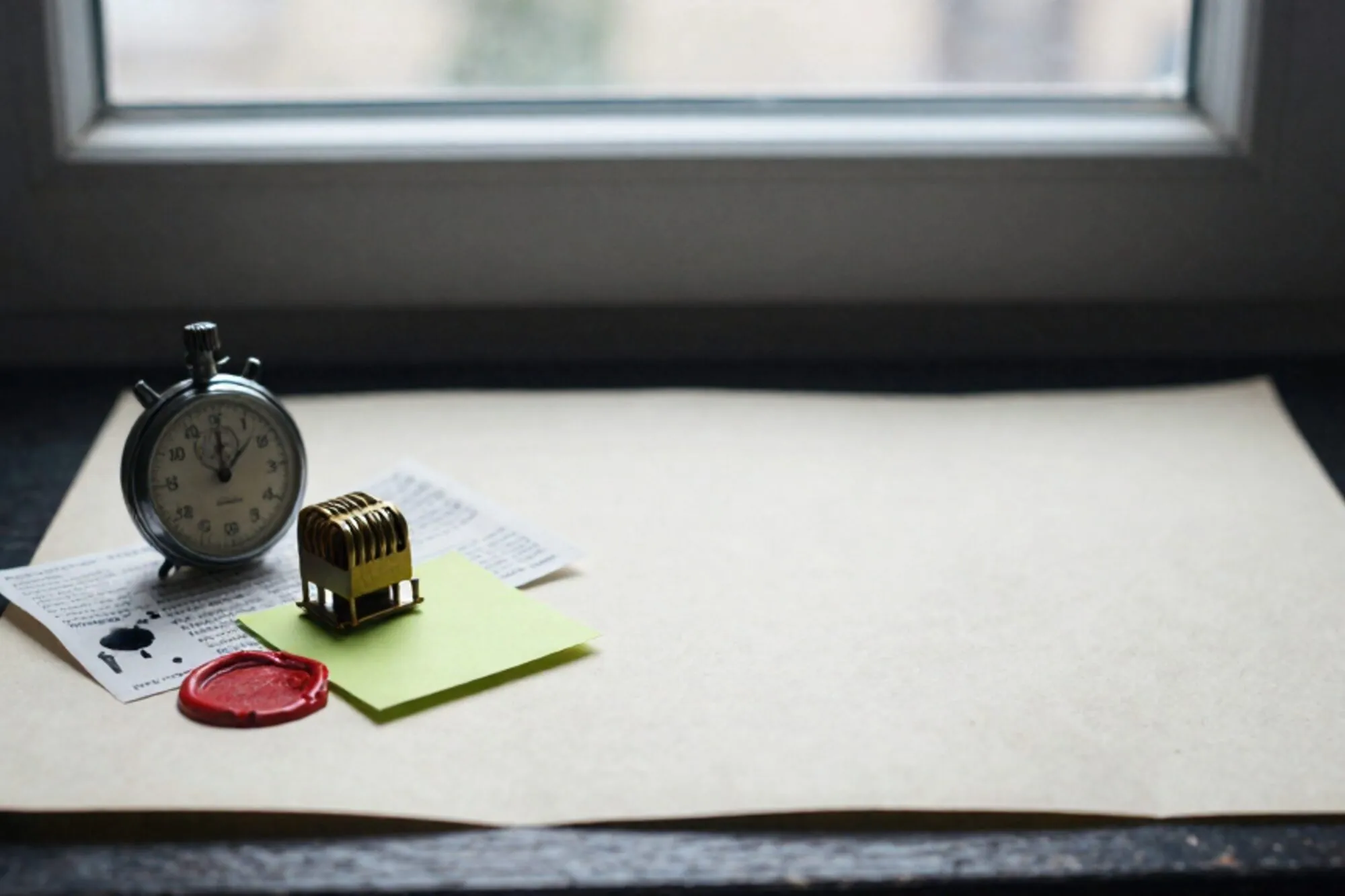 Brass relay coil, vintage stopwatch at 3:14, folded telegram, chartreuse sticky note, red wax sliver on ivory blotter.